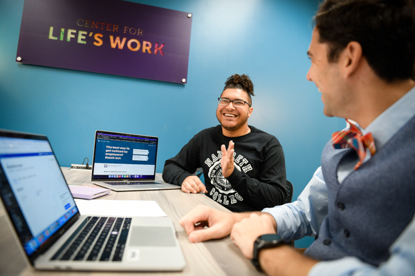 student laughing with their career coach
